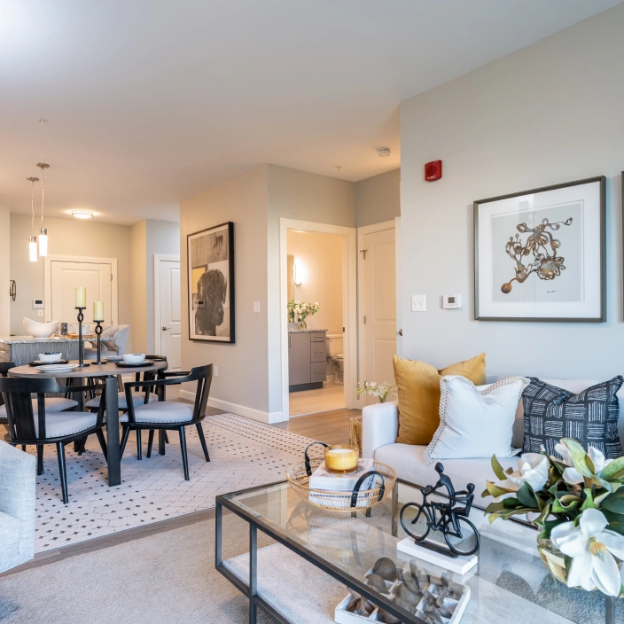 Open concept living and dining area with modern decor and soft neutral wall palette